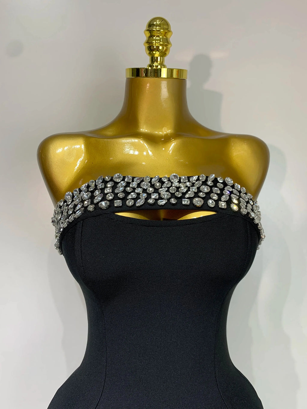 Side angle of the glamorous dress highlighting its curve-hugging design and sparkle.