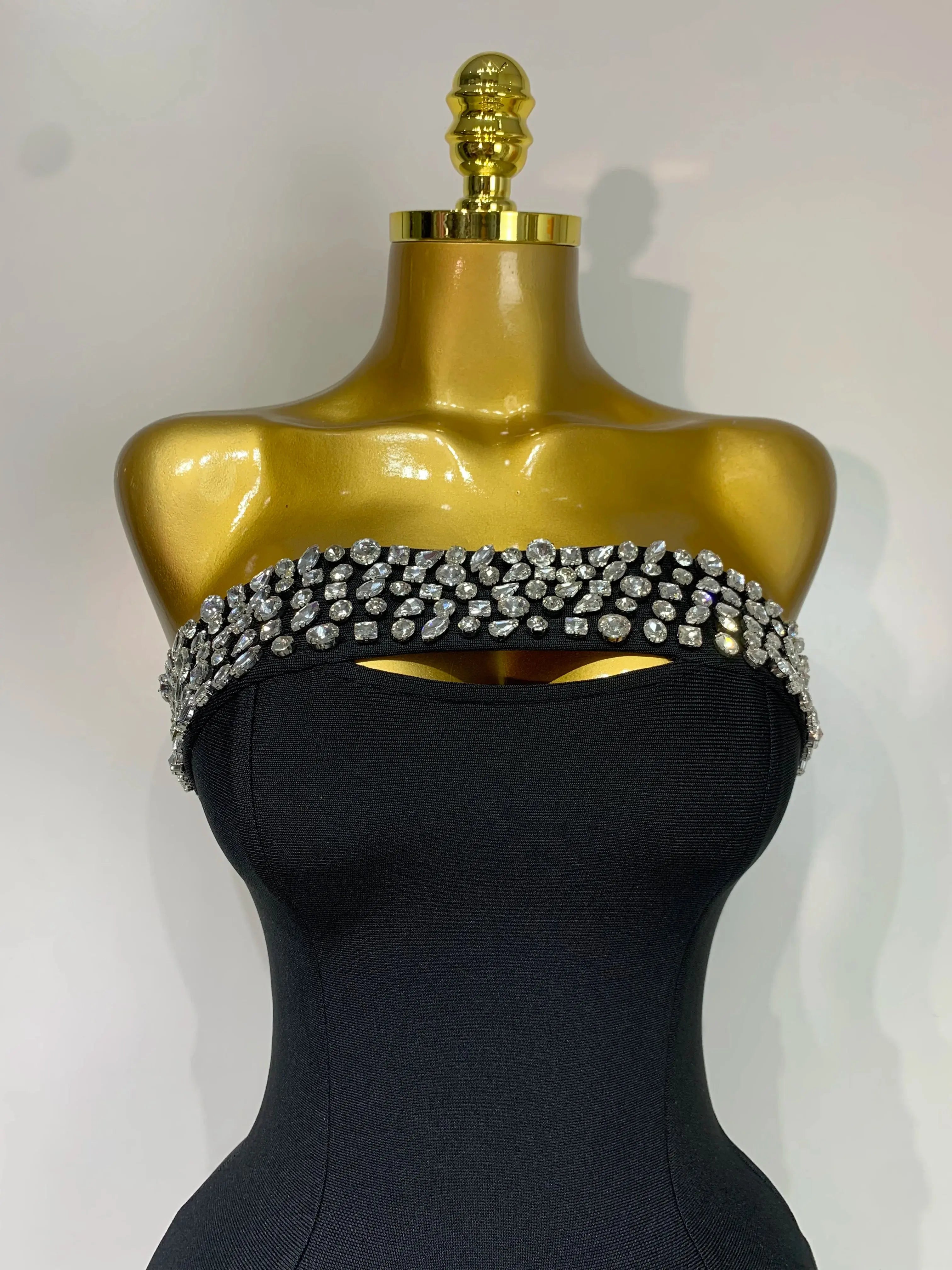 Side angle of the glamorous dress highlighting its curve-hugging design and sparkle.