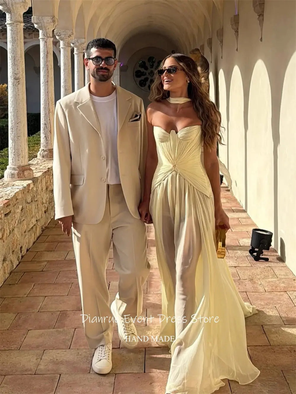 Model showcasing the floor-length yellow chiffon gown at a gala event.