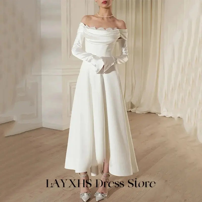 Detail shot of the detachable lace shoulders on the enchanting wedding dress for versatile styling.