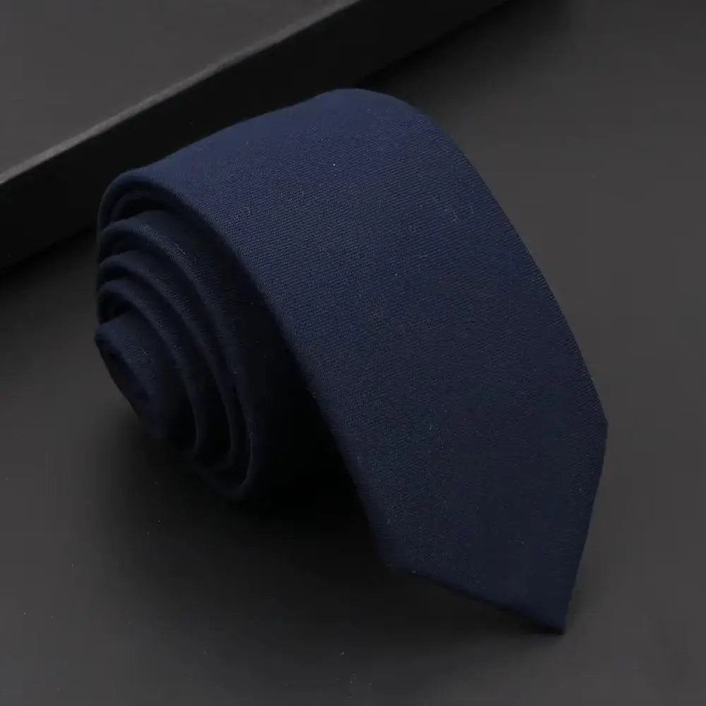 Refined black necktie, perfect for high-stakes boardroom settings.