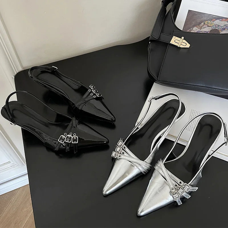 Versatile black sandals styled for both cocktail dresses and sharp trousers.