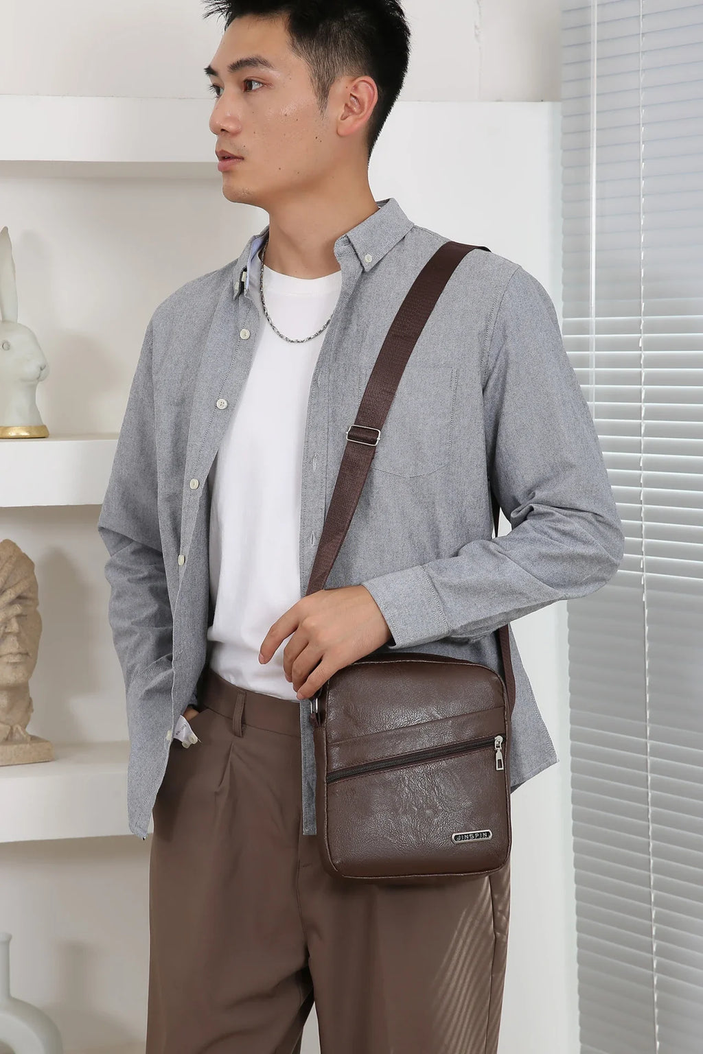Sleek black messenger bag combining weatherproof protection with professional style aesthetics