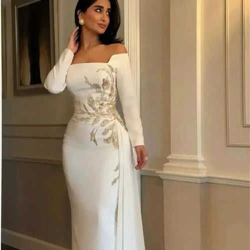 Close-up of satin fabric showcasing intricate beading on the off-shoulder design.