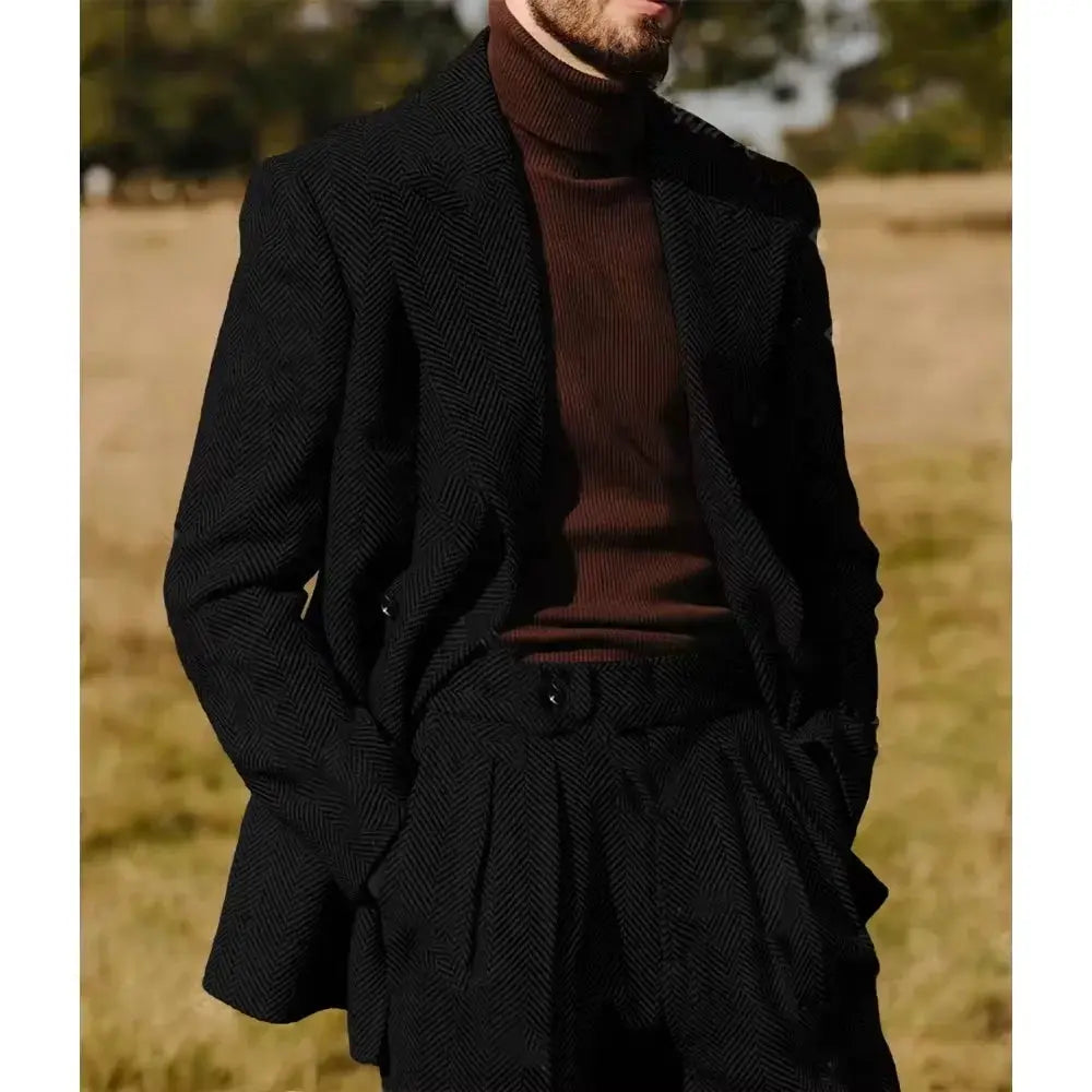Herringbone suit laid flat, highlighting its durable fabric and sharp lines.