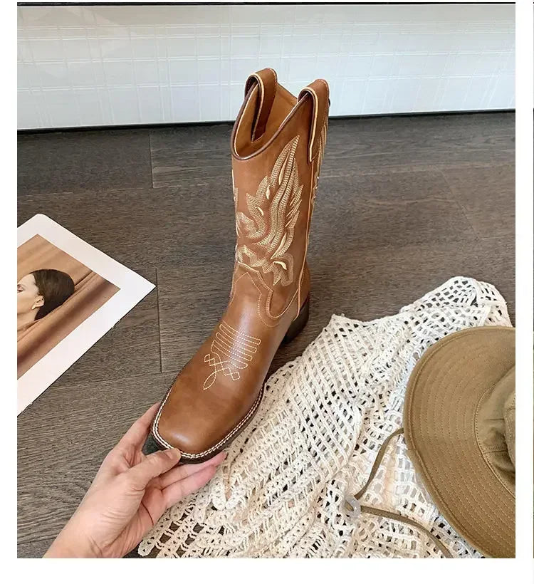 Slip-on leather boots with Western embroidery details and mid-calf coverage