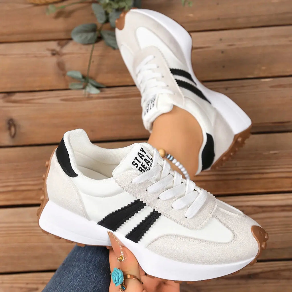 Lightweight white sneakers showcasing breathable material for all-day comfort.