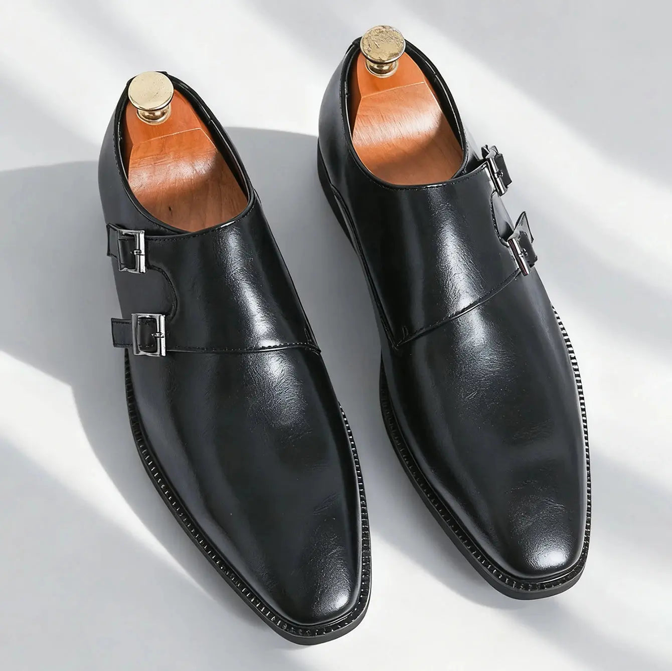Model wearing monk strap leather shoes at a boardroom, exuding confidence and style.