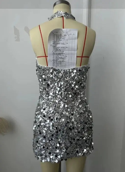 Side view of sleeveless sequin dress, emphasizing its flattering silhouette and natural waistline.