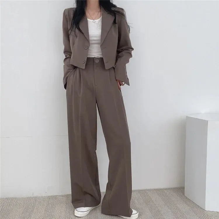 Elegant women's suit displayed on a hanger, showcasing its sophisticated British style.