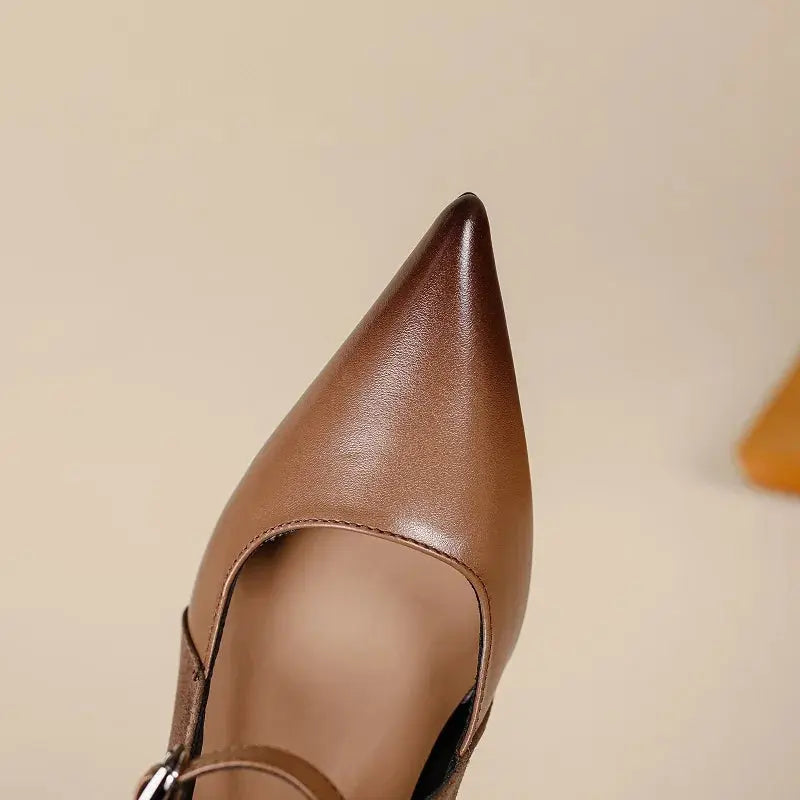 Side view of pointed toe leather slingback pumps with adjustable back strap and sky-high heel