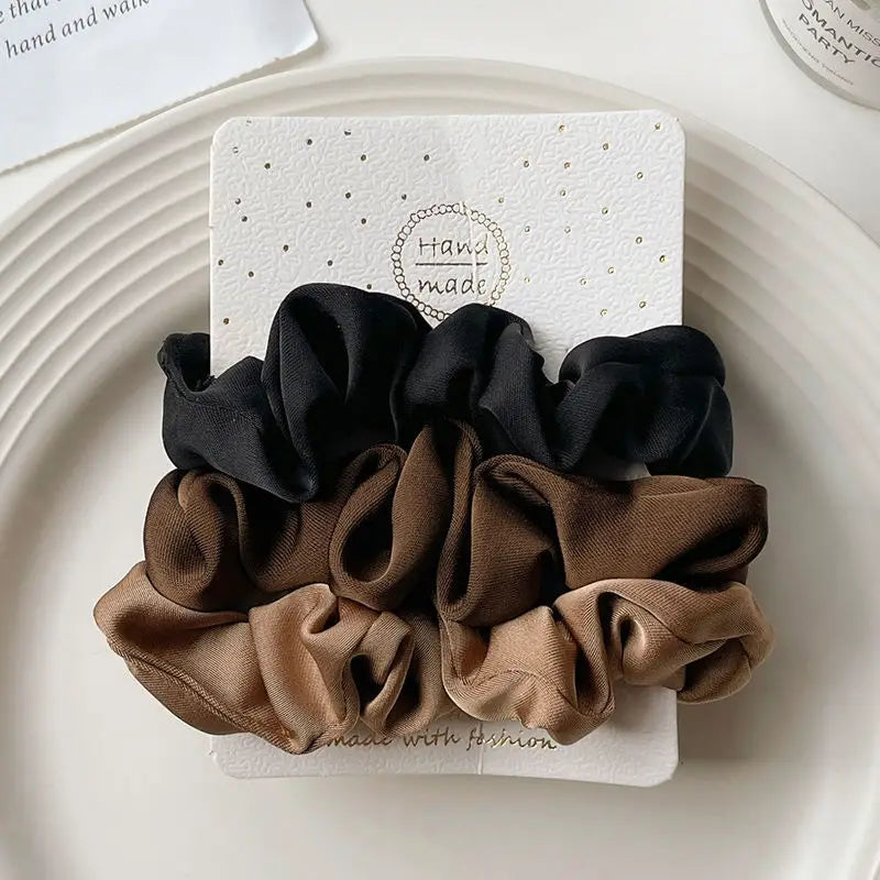 Premium satin scrunchies protecting precious strands during active wear