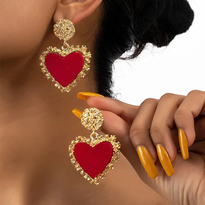 Heartfelt Whispers Dangle Earrings in zinc alloy with a vintage heart design, sparkling in light.