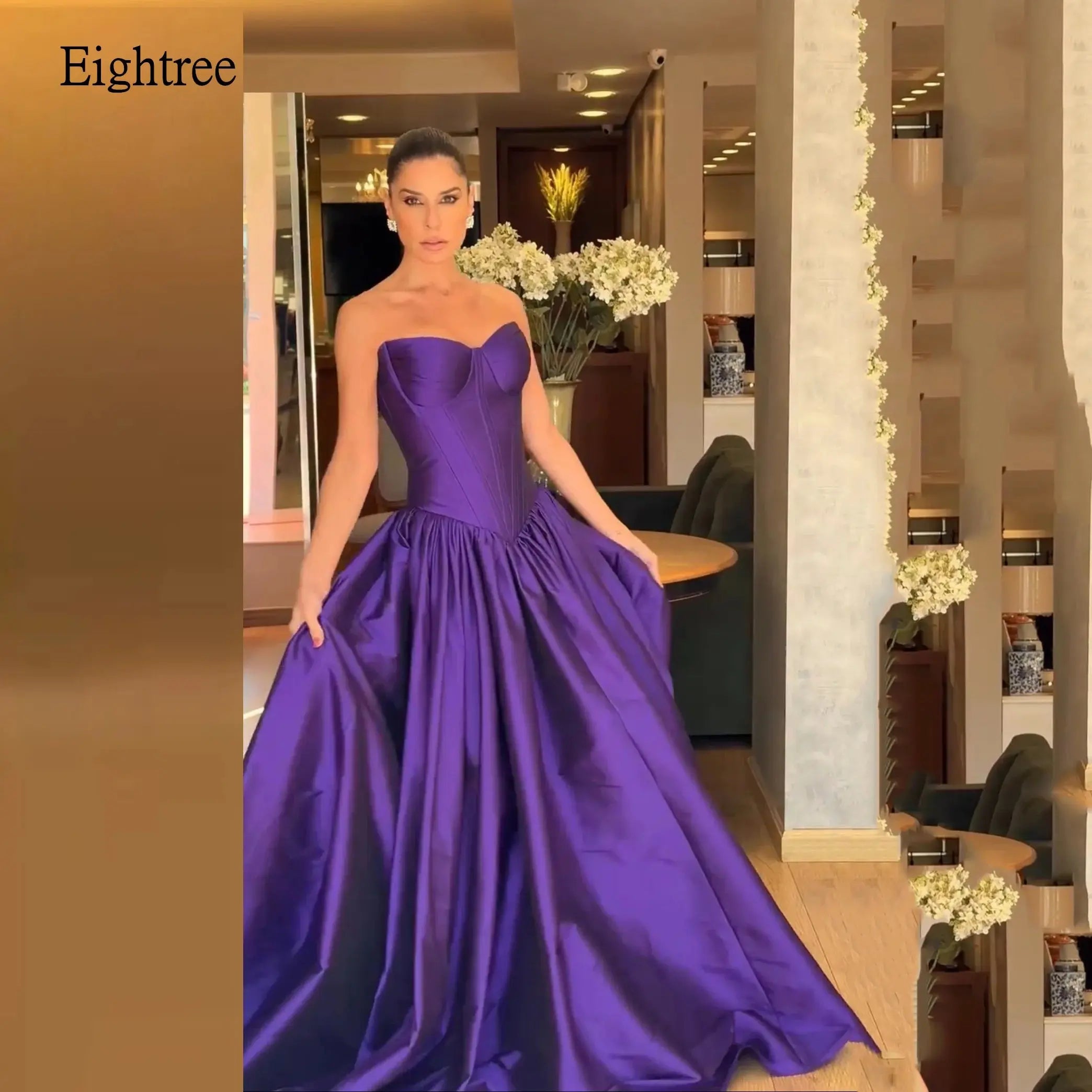 Purple satin prom dress with sweetheart neckline and backless design.