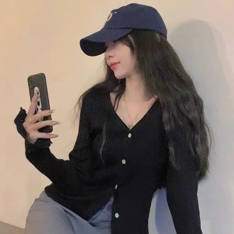 Autumn Whisper cardigan draped over a chair, showcasing its versatility for any occasion.