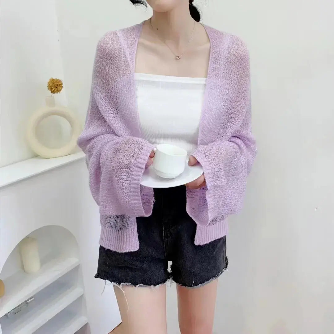 Model walking along a boardwalk in the Summer Breeze Knit Cardigan, embodying casual chic style.