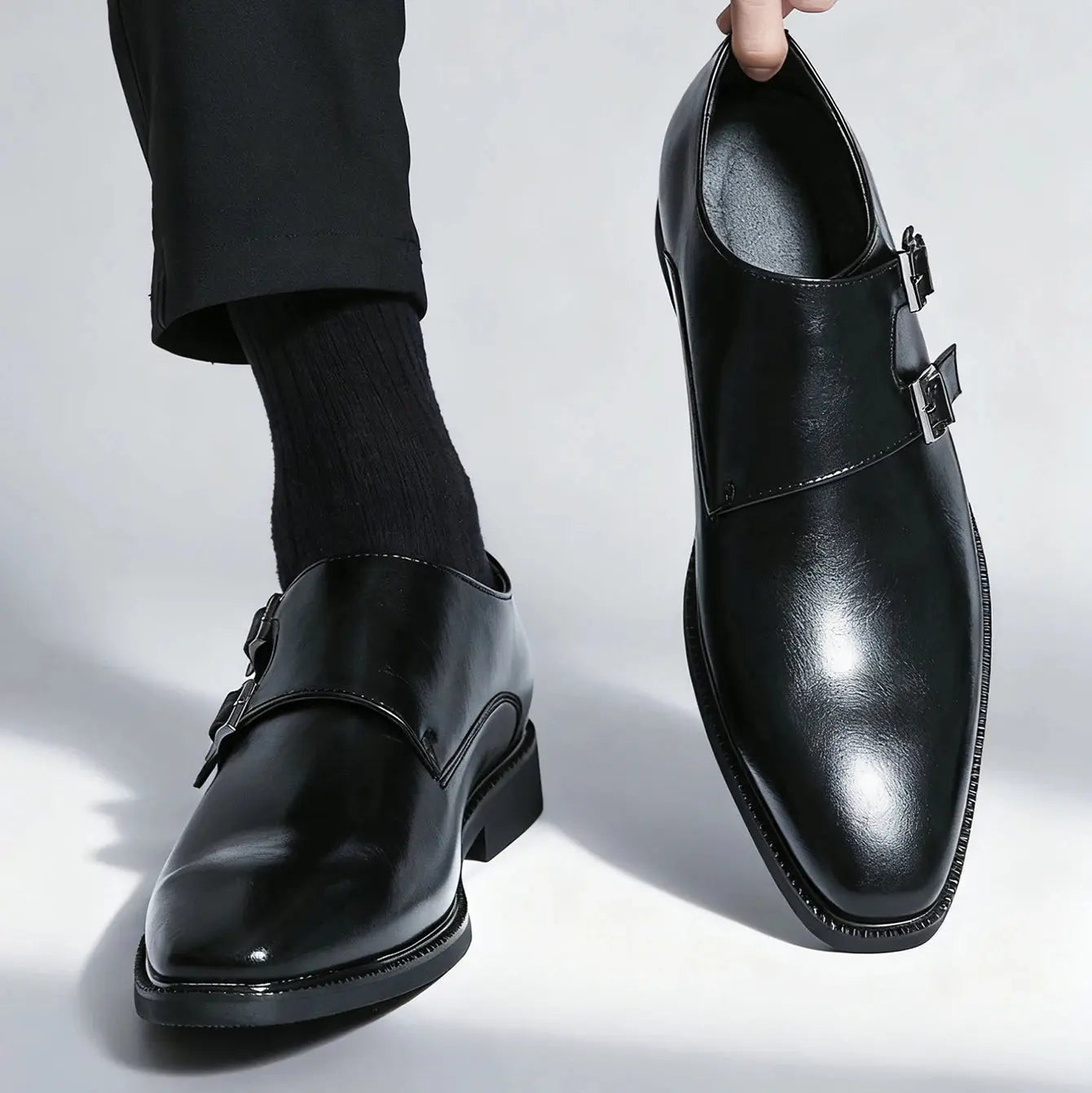Monk strap leather shoes displayed on a wooden surface, emphasizing their sophisticated style.
