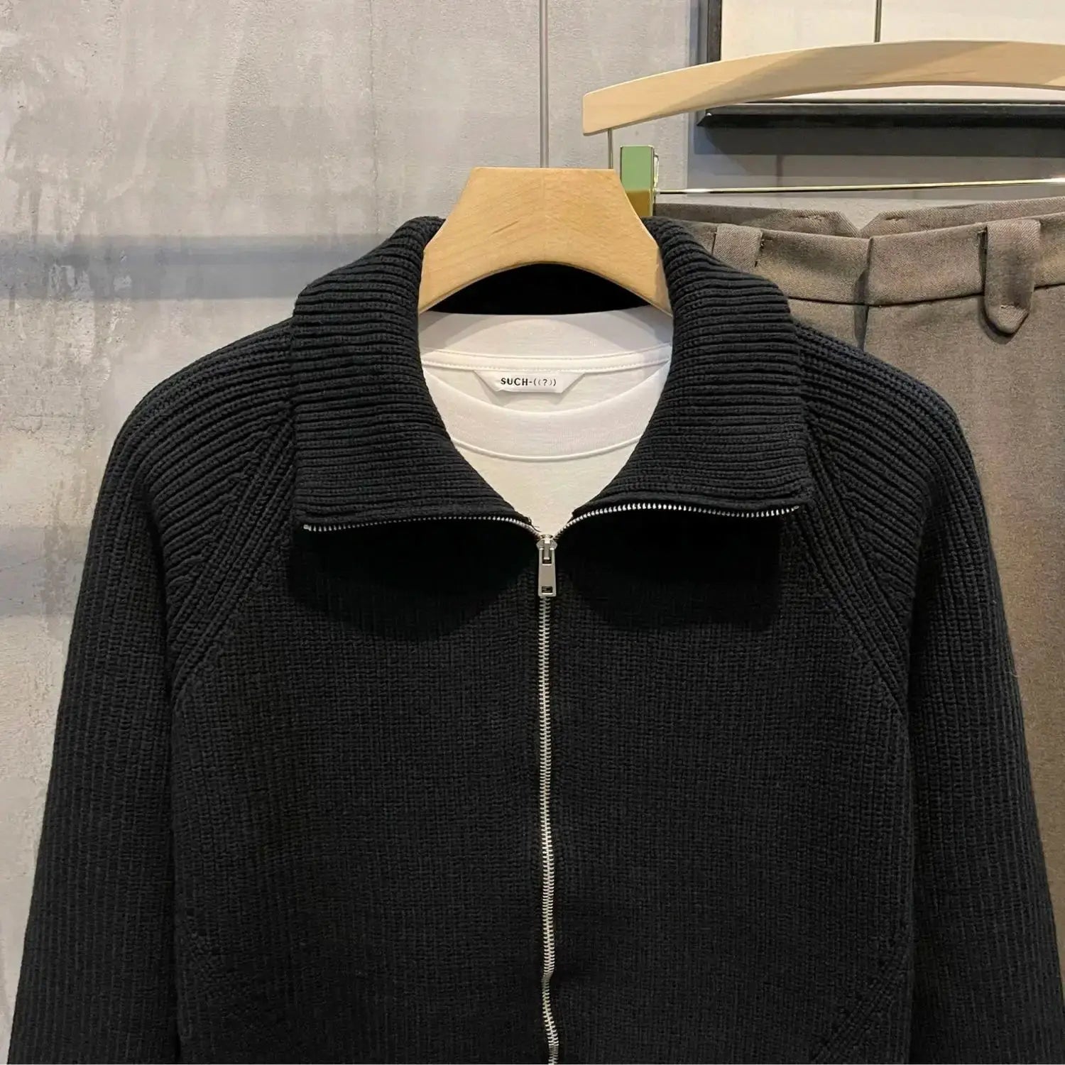 Back view of the navy cardigan, highlighting its tailored fit and stylish design.