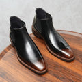 Pair of executive leather Chelsea boots in black showing slip-on convenience and tailored fit