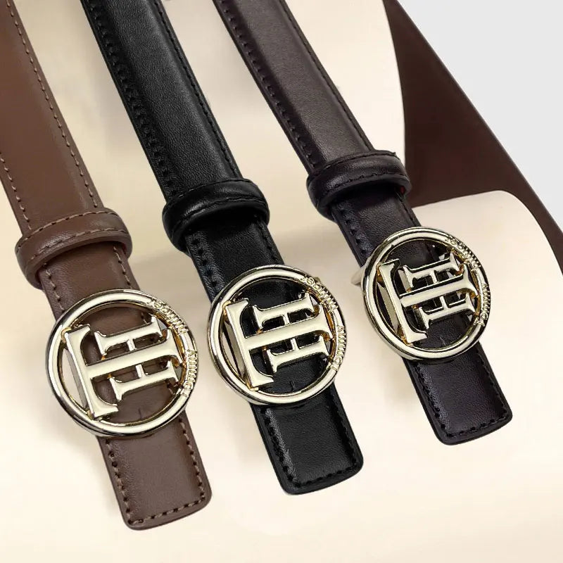 Sleek black faux leather belt with elegant letter patterning.