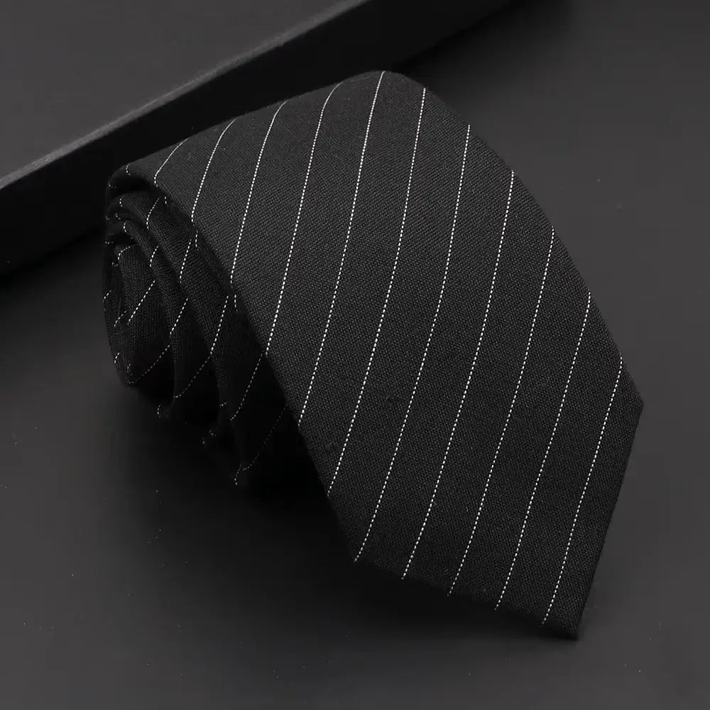 Solid black necktie, versatile for various formal occasions.