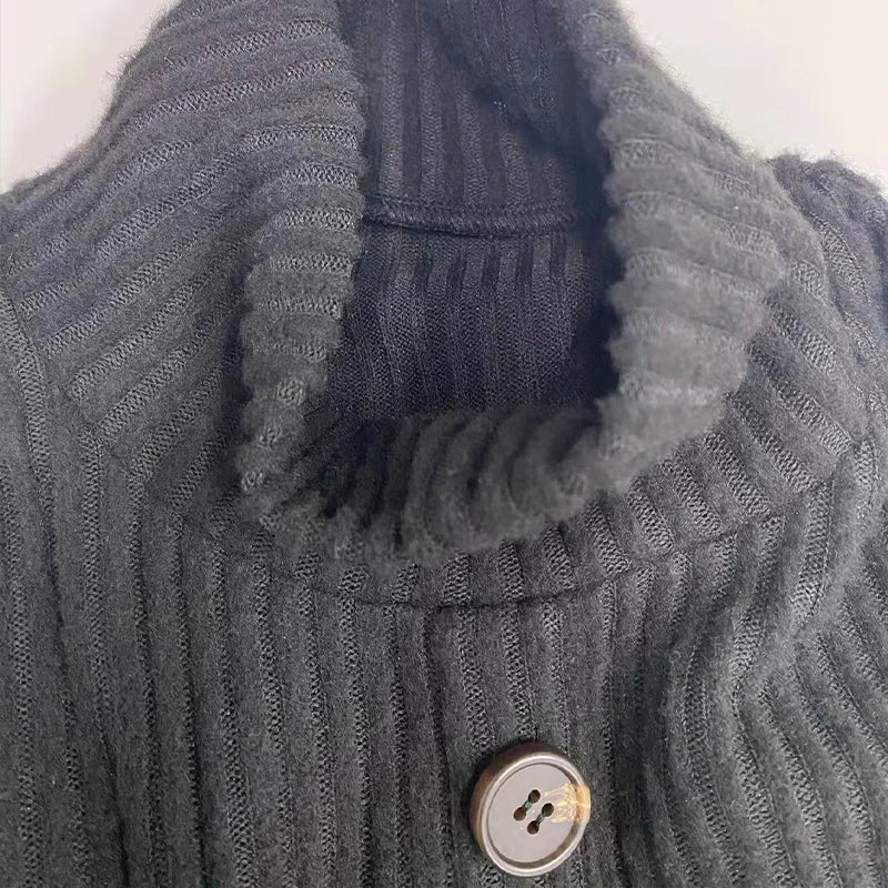 Side view of Black Knit Maxi Dress, illustrating its long sleeves and sophisticated design.