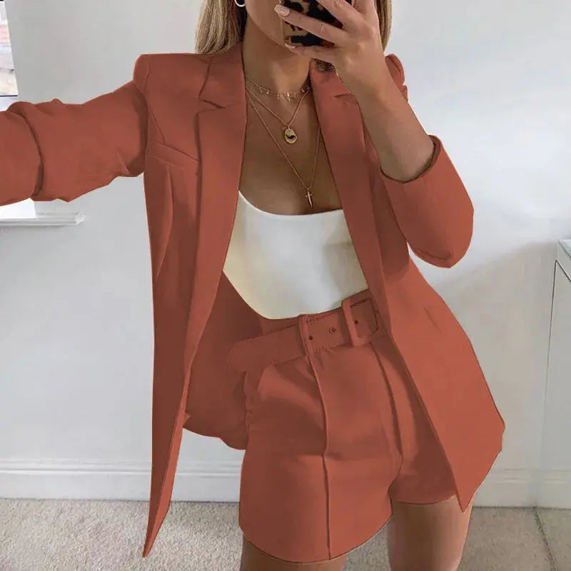 Model wearing navy blazer and shorts set, exuding modern professional attire.