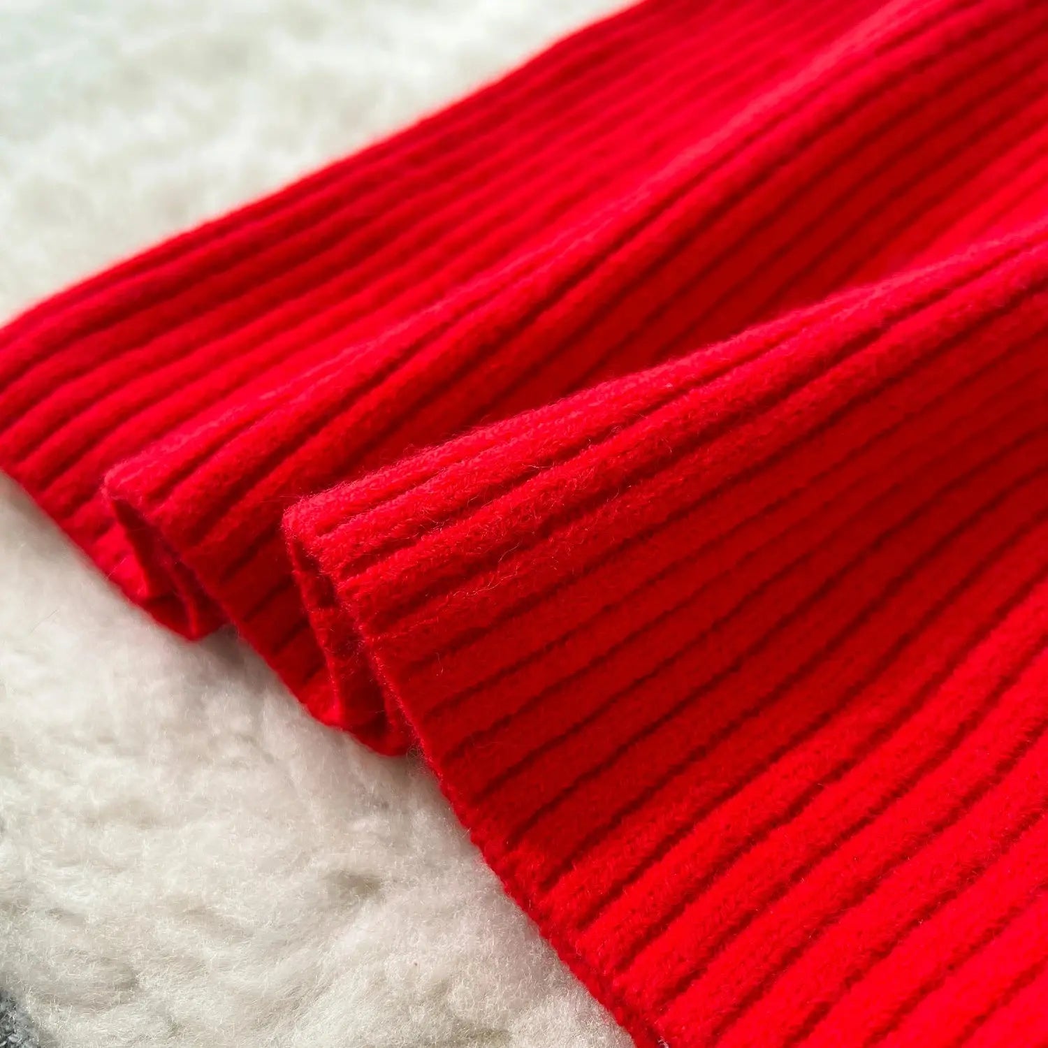 Close-up of the warm knit texture of the Winter Whisper Dress, showcasing its cozy fabric.