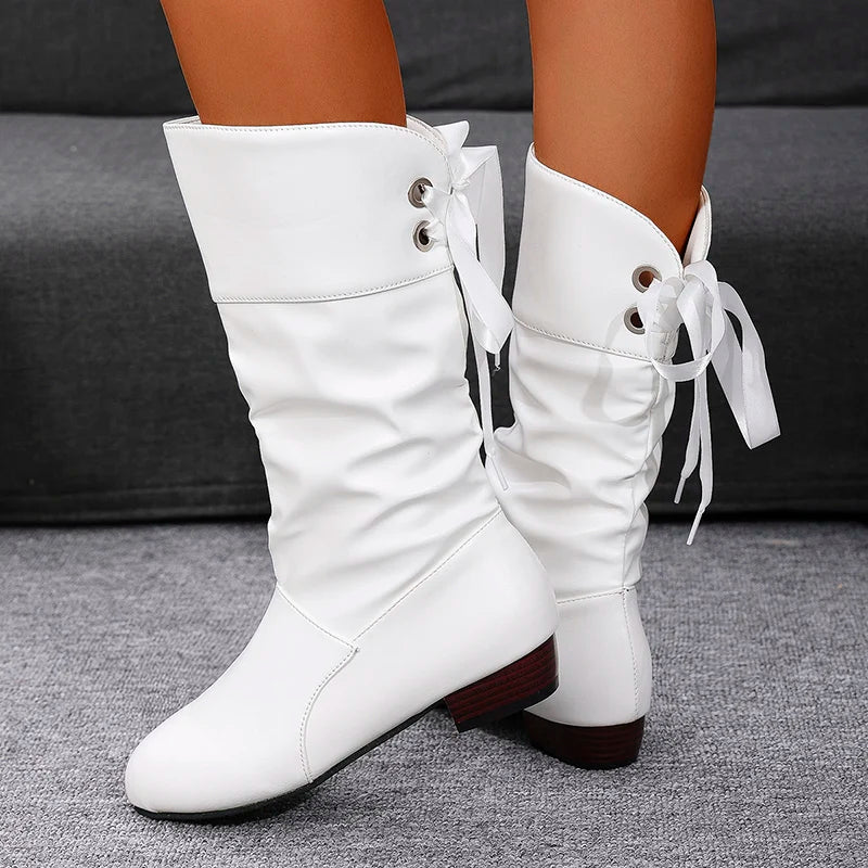 Women's western style boots featuring distinctive pleated leather texture and low square heel