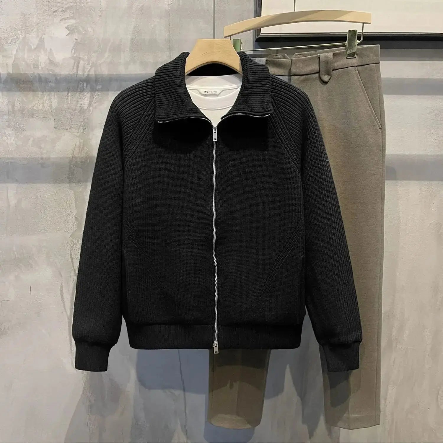 Close-up of the smooth zipper closure on the navy zip-up cardigan, ensuring easy wear.