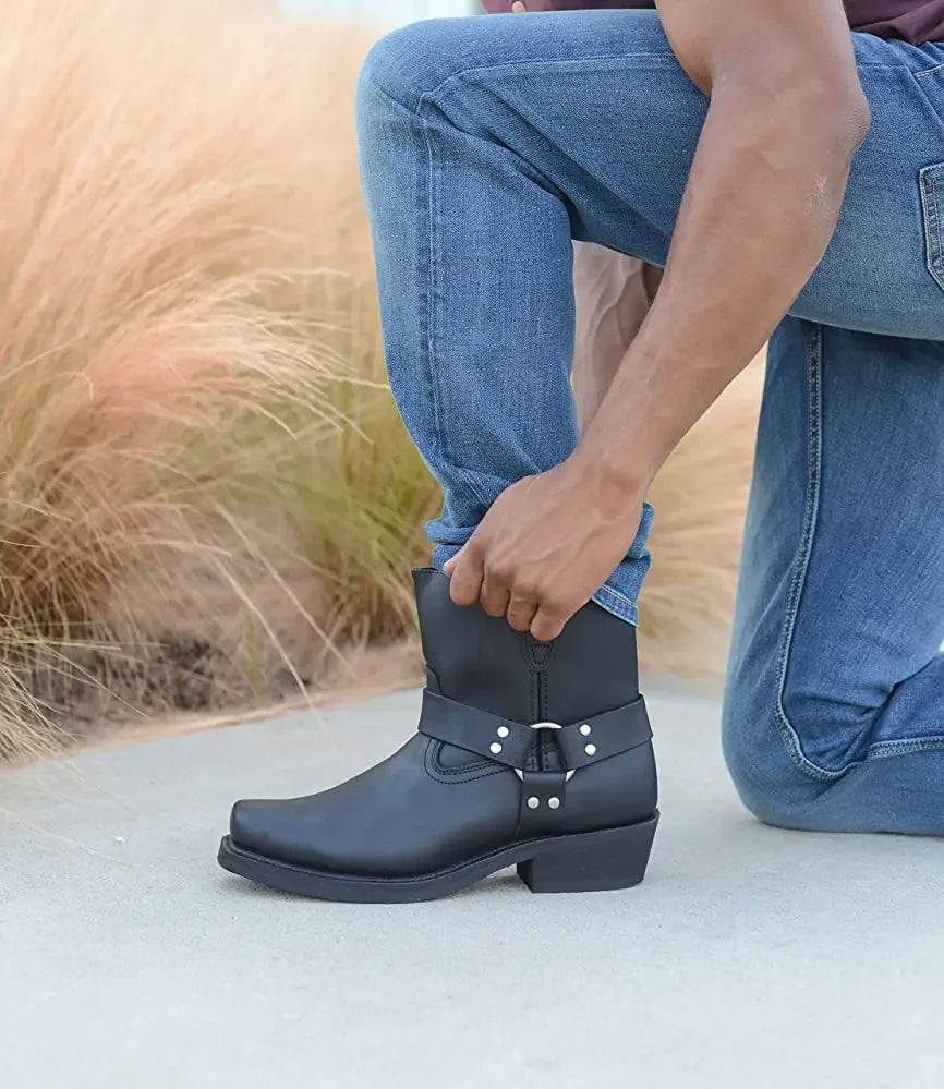Rugged black riding boots with rivets, merging modern cowboy and motorcyclist aesthetics.
