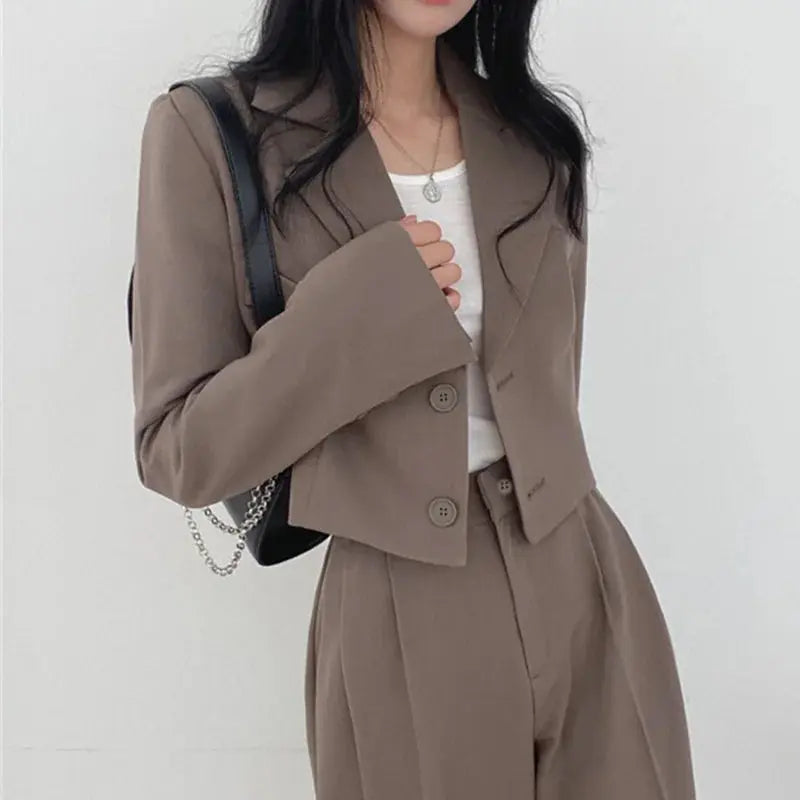 High-rise wide-leg pants of the suit, emphasizing their modern professional appeal.