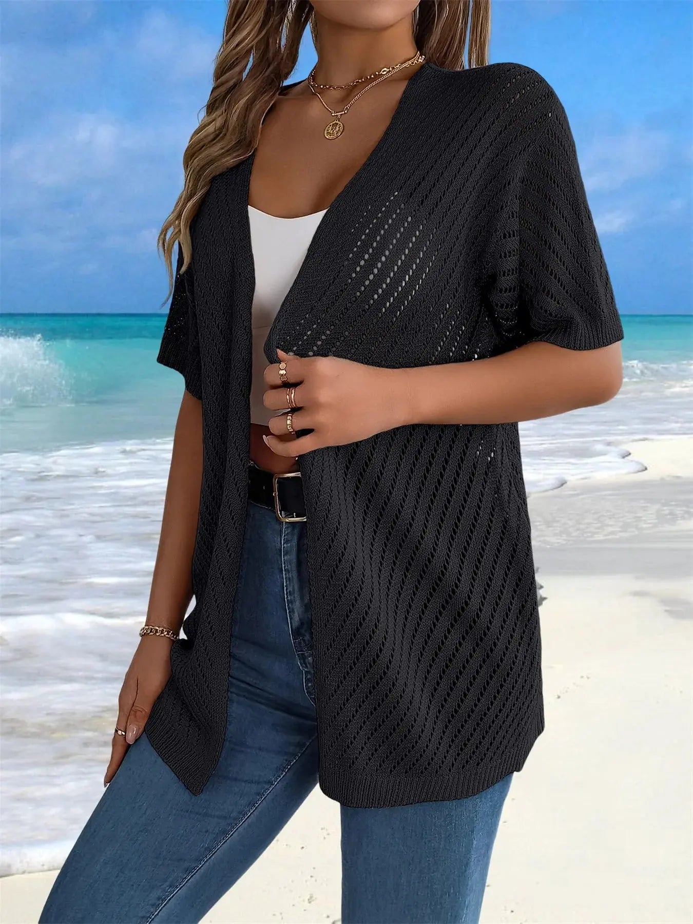 Close-up of the intricate crochet pattern on the lightweight cardigan.