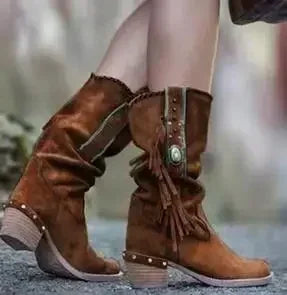 Close-up of square heel and metal decorations on mid-calf suede boots