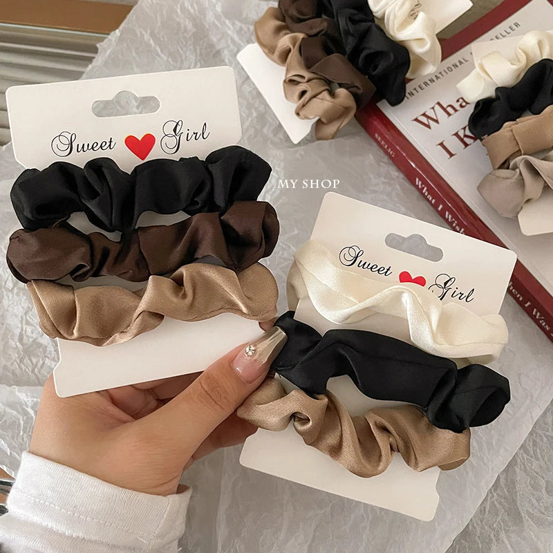 Silky satin hair scrunchies in elegant colors for gentle hold and damage-free styling