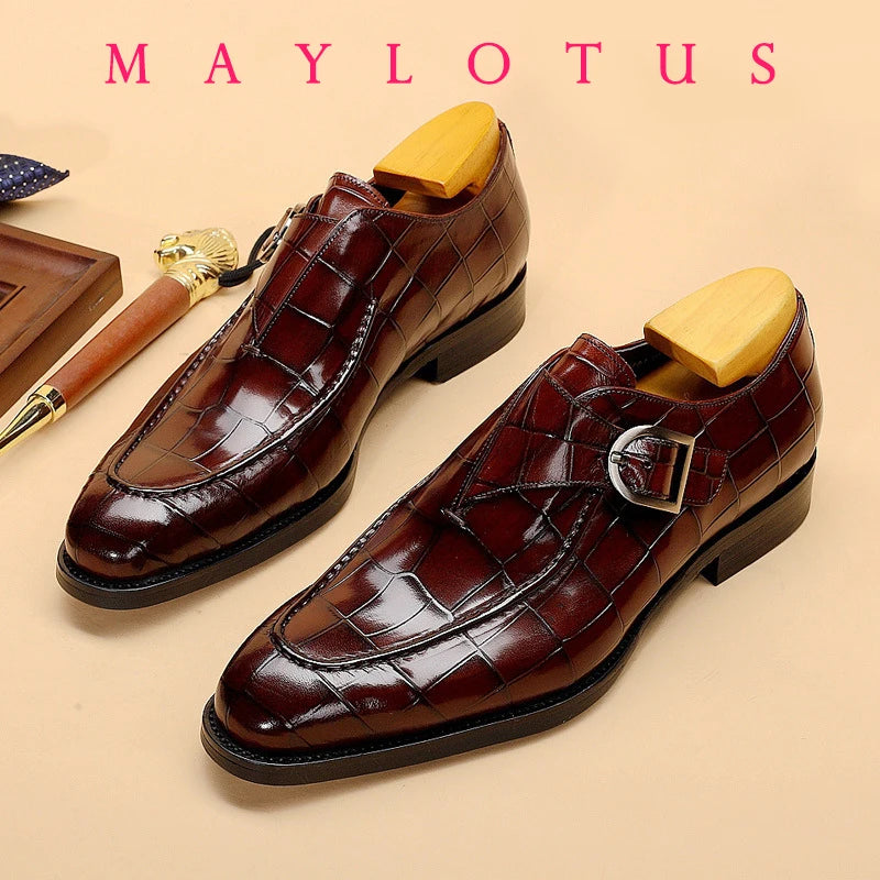 Polished black full-grain leather Oxfords with pointed toes and sleek buckle.