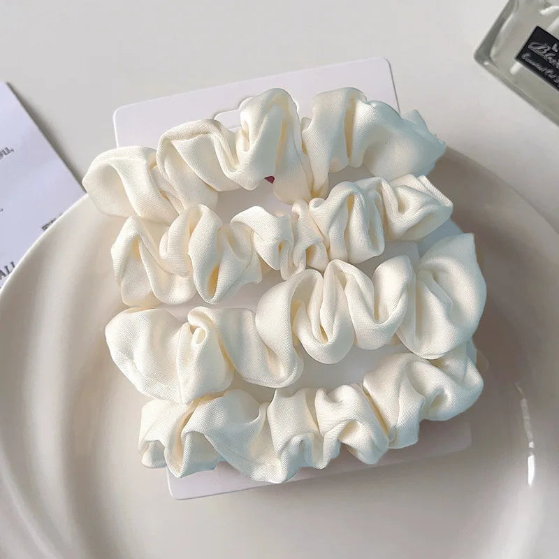 Flexible satin scrunchies providing comfortable hold for morning meetings and beyond