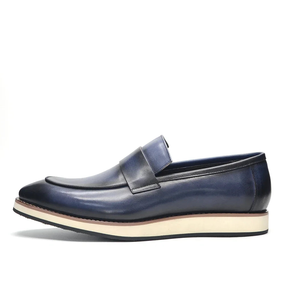 Side view of classic black leather penny loafers with modest heel and slip-on construction