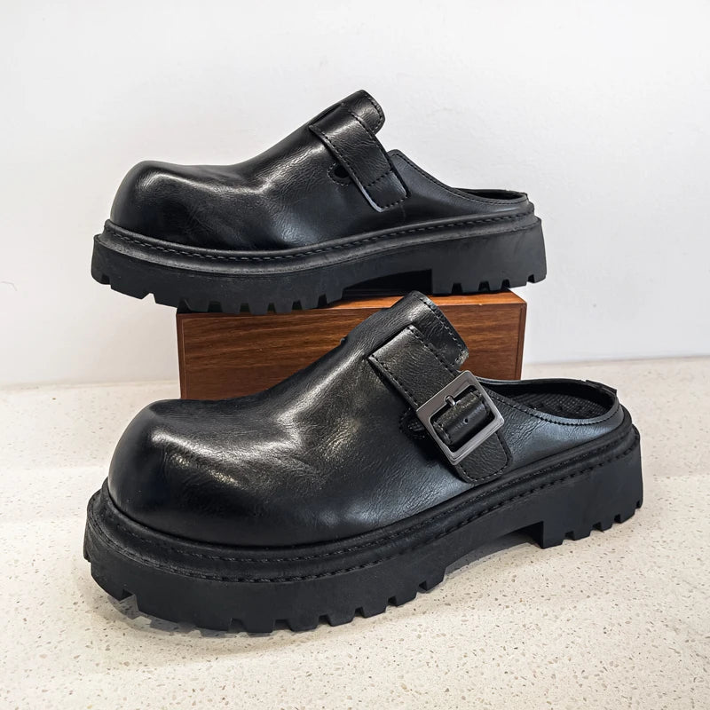 Black leather platform mules featuring sleek backless construction and metal accent