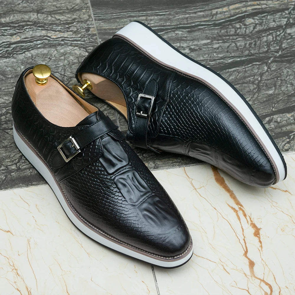 Close-up of crocodile-embossed leather texture and hasp buckle detail on premium monk strap shoes