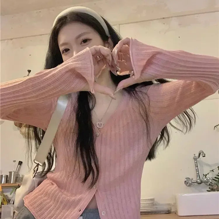 Model layering the Autumn Whisper cardigan over a dress, perfect for transitional weather.