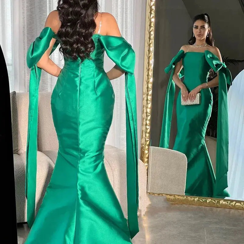 Full-length emerald evening gown with a flowing satin fabric, perfect for grand events and galas.