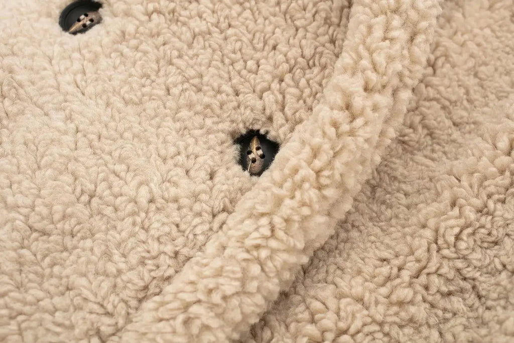 Winter Whisperer coat displayed on a hanger, showcasing its elegant design and modern elegance.