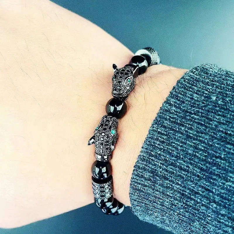 Elegant beaded bracelet featuring copper beads and a striking leopard charm for a bold statement.