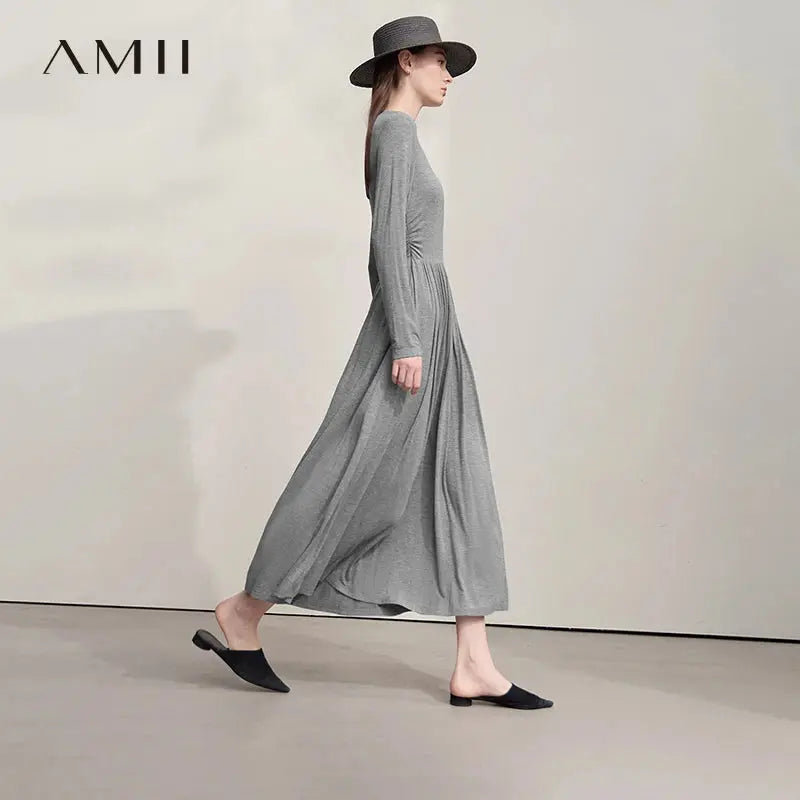 Mid-calf knit dress in soft black viscose blend, perfect for boardroom meetings.