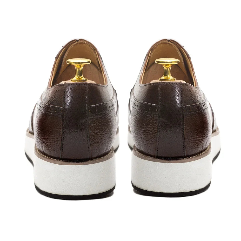 Brown handcrafted Oxford shoes showing premium leather construction and decorative perforations