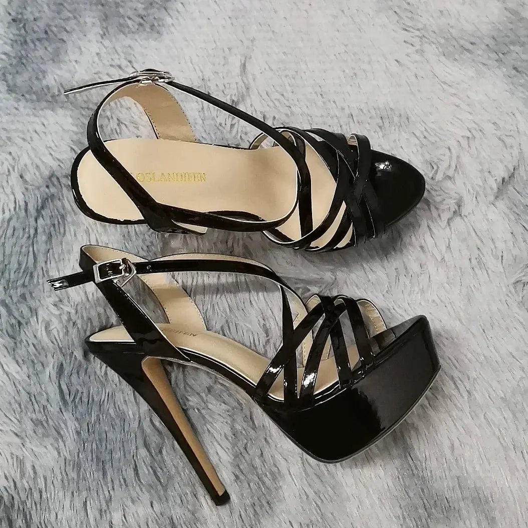 Black snakeskin high heels with ankle strap and stiletto design.