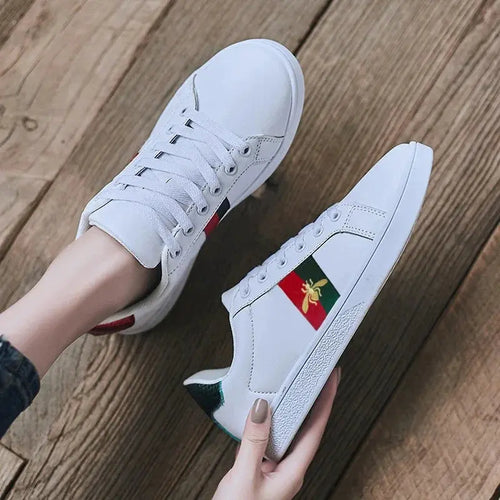 Side view of microfiber sneakers featuring signature bee embroidered design