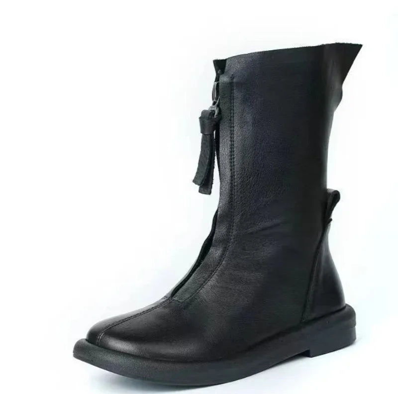 Mid-calf boots paired with jeans, perfect for cold weather commuting