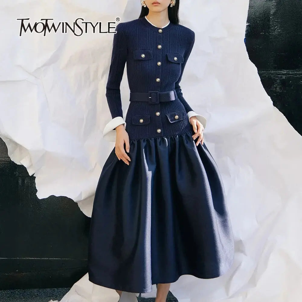 Chic knit dress in black with unique button detailing and elegant folds.
